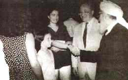 Mujadadi shakes hand with a girl
