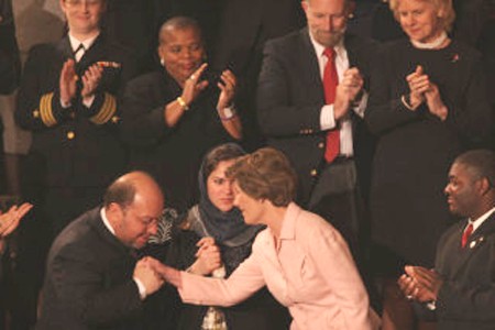 Hamid Gailani kisses Laura Bush's hand